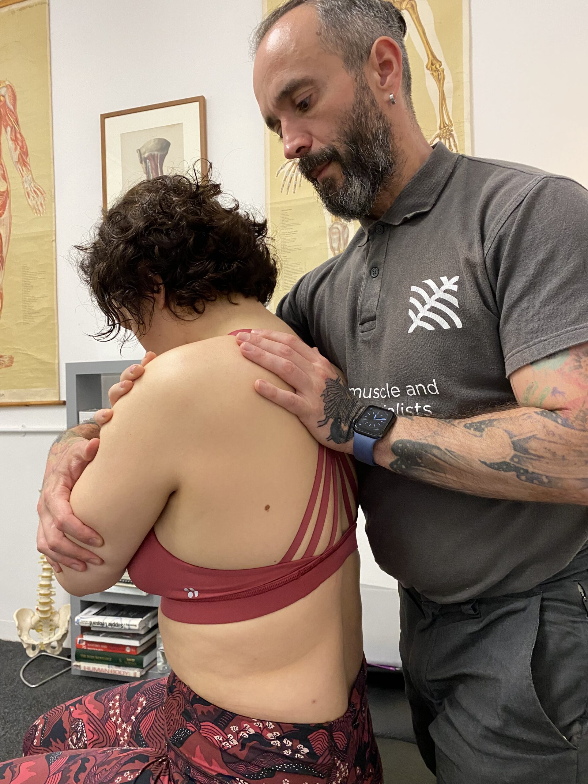 Jose Fernandez assessing a patient’s shoulder in the clinic