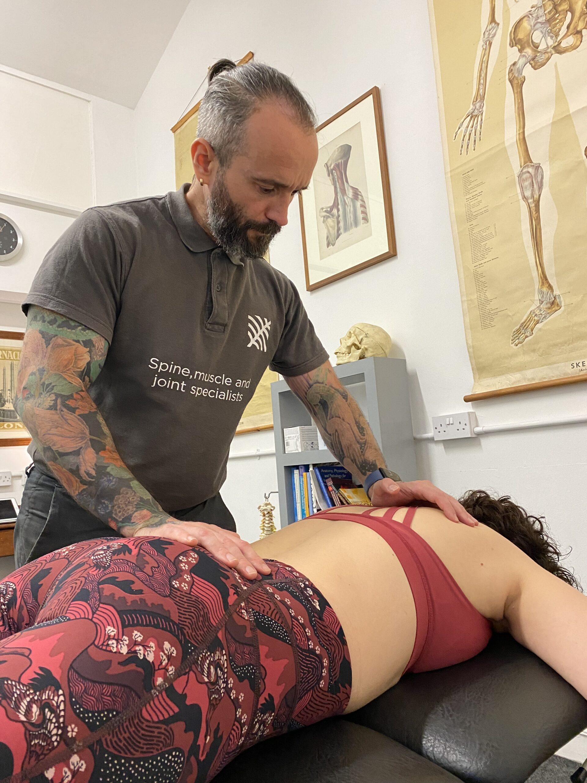 Jose assessing a patient’s back